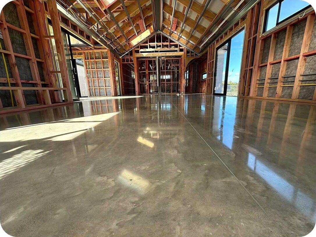 Natural polish concrete floor in a timber framed new build, cement cream retained with a soft reflection