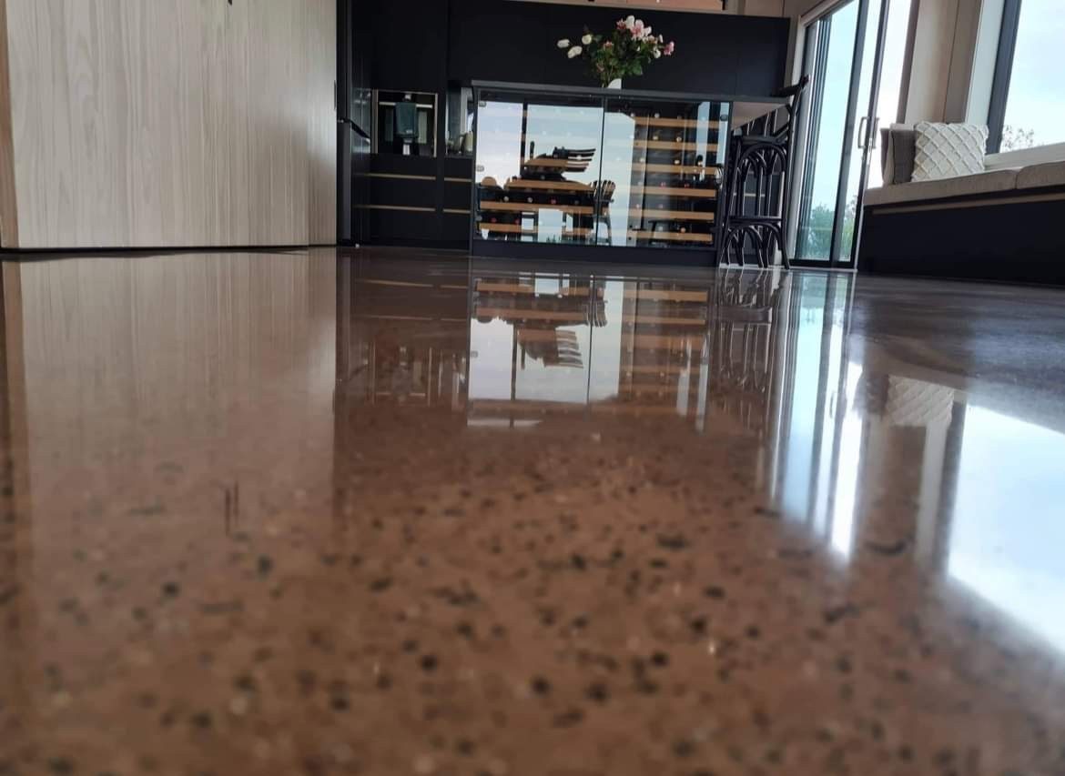 Polished concrete surface showing pigment and fine aggregate under raking light