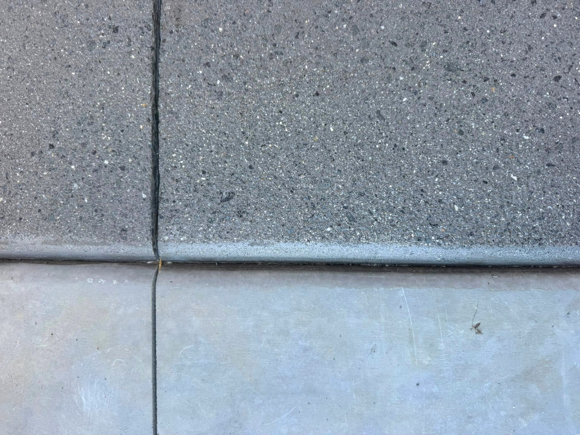 Macro view of exposed aggregate beside a smoother ground panel